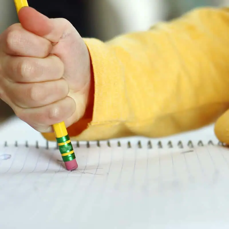 View from the back of a young girl practicing handwriting