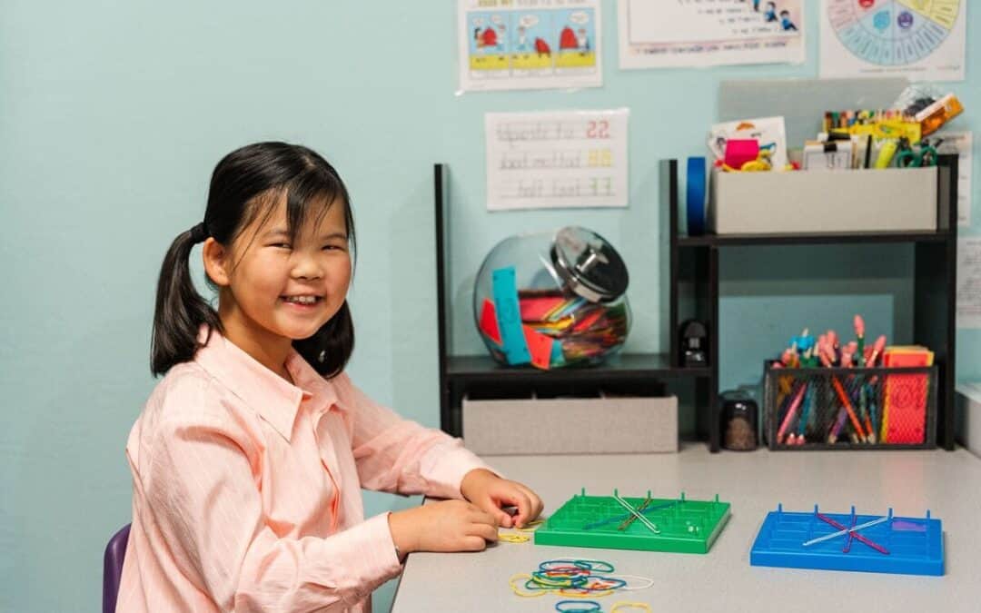Young asian girl at a desk working on a puzzle