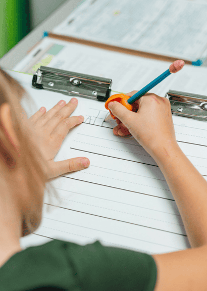 young girl holding pencil